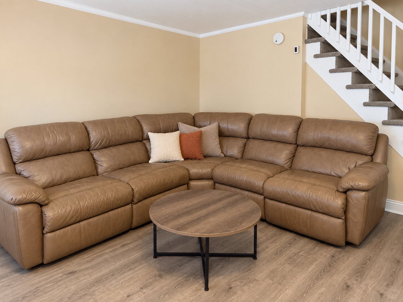 A sitting area in an Evo Living home: a sectional sofa and a coffee table.